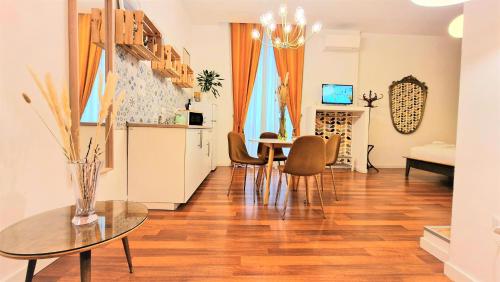 a living room with a dining room table and chairs at Napoli Tree - Lungomare in Naples