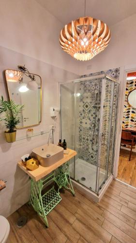 a bathroom with a glass shower and a sink at Napoli Tree - Lungomare in Naples