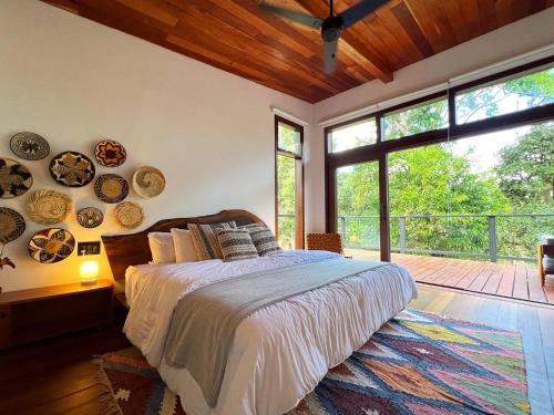 a bedroom with a bed with plates on the wall at Finca Panda in Boquete