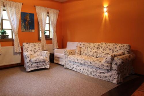 a living room with a couch and a chair at Apartment Bohinjčan in Bohinj