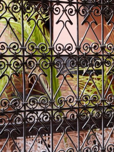 a close up of an iron fence with a window at Riad Musa in Marrakesh
