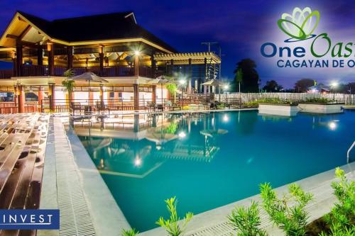 a resort with a swimming pool at night at Furnished 2Br Condo With Balcony in Cagayan de Oro