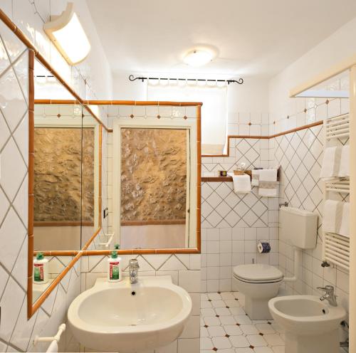 a bathroom with a sink and a toilet at B&B I Coppi in San Gimignano