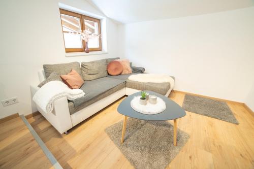 a living room with a couch and a table at Ferienwohnung am Wald in Waidring