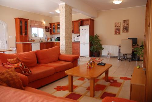 a living room with a couch and a table at Villa Italiana in Agios Nikolaos