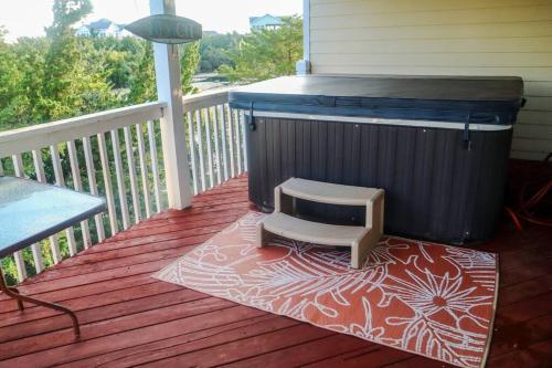 a dog sitting on a deck with a heater at Lake Front Modern Beach House-Hatteras Island in Avon