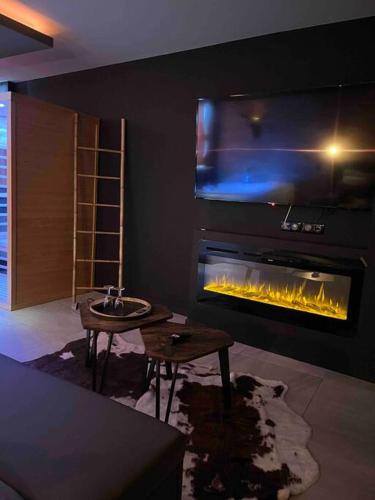 a living room with a fireplace and a table at Sweet love rustic/chic in Espaly-Saint-Marcel
