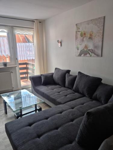 a living room with a couch and a glass table at Altstadtperle in Emden