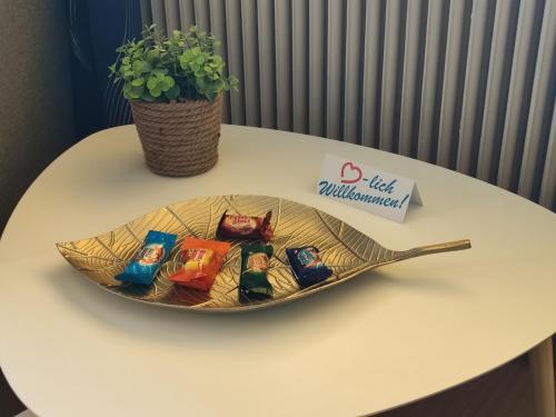a bowl of chocolates on a table with a plant at Pension zum Mühlrad in Millstatt