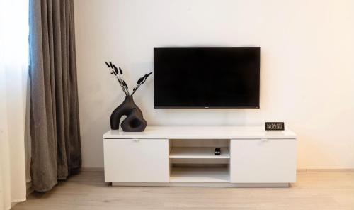 a white cabinet with a television on top of it at Tran Chien Apartment with free private parking in Prague