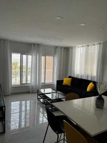 a living room with a couch and a table and chairs at מישל נופש ,צופית תחתית 6003 in Eilat