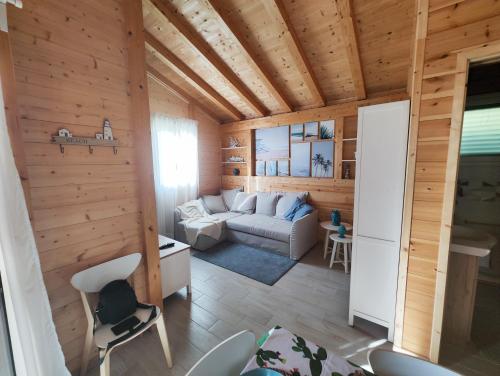 a living room with a couch and a table at Casa Vacanze La Fenice - Casa Atlantica in Cava dʼAliga
