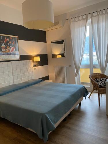 a bedroom with a large bed and a large window at Maison Del Magra in Ameglia