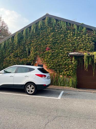 a white car parked in a parking lot in front of a building at La casa Arancione in Boves