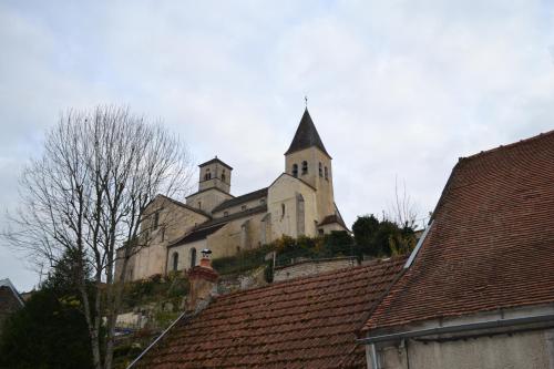 an old church with a steeple on top of roofs at Gites Rural De La Douix in Châtillon-sur-Seine