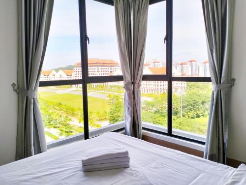 a bedroom with a bed and a large window at Bell Suites by Salaam Suites, Sepang in Sepang