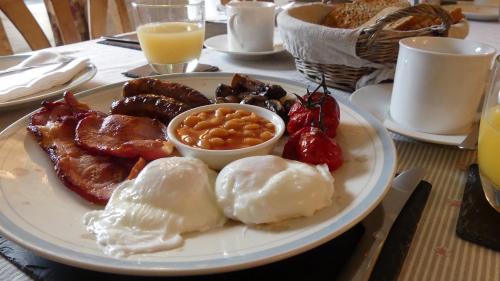 a plate of breakfast food on a table at Higher Trenear Farm B&B in Helston