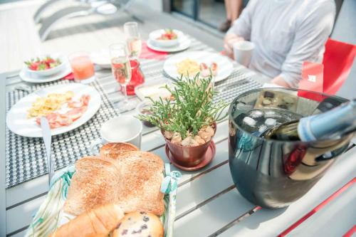 a table with bread and other foods on it at Kruger Cliffs Lodge - Absolute privacy guaranteed in Hoedspruit