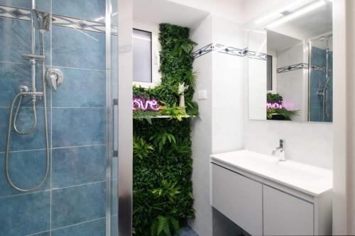 a bathroom with a shower with a green wall at My Sweet Home in Genoa