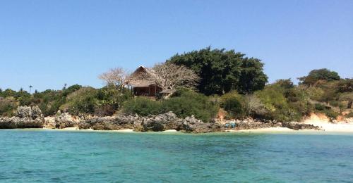 a house on a small island in the water at Belmoz Beach House in Chuca