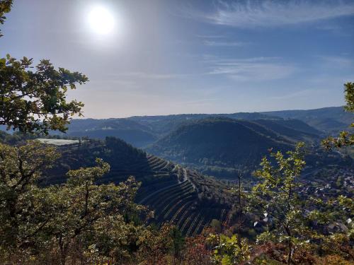 a view of a valley with the sun in the sky at Maison avec magnifique vue et piscine privative in Saint-Félix-de-Lunel