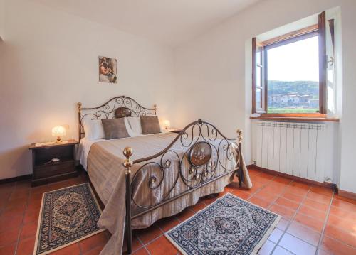 a bedroom with a bed and a large window at Villa Fornace by Mmega in Casella