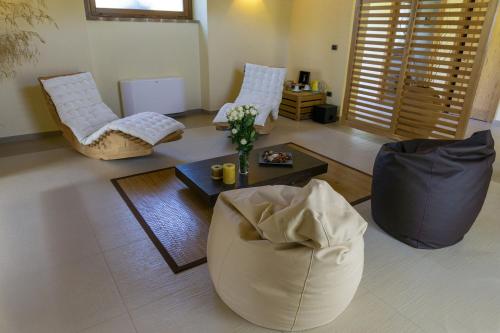 a living room with two chairs and a coffee table at Villa Fornace by Mmega in Casella