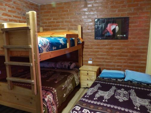 a bedroom with two bunk beds and a bed at Hostal La Casa Amarilla City in Baños