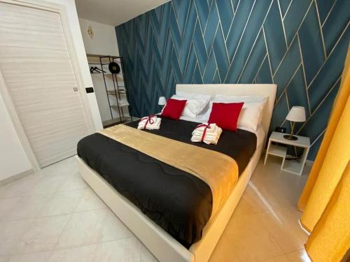 a bedroom with a large bed with two red pillows at Pontecorvo Naples Apartament in Naples