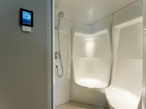 a bathroom with a toilet with a tv on the wall at Rakuten STAY VILLA Kamogawa Building C with Terrace and sauna Capacity of 10 persons in Kamogawa