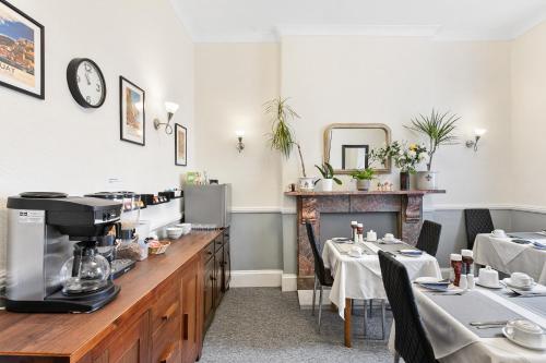 a restaurant with two tables and a coffee machine at South view in Torquay