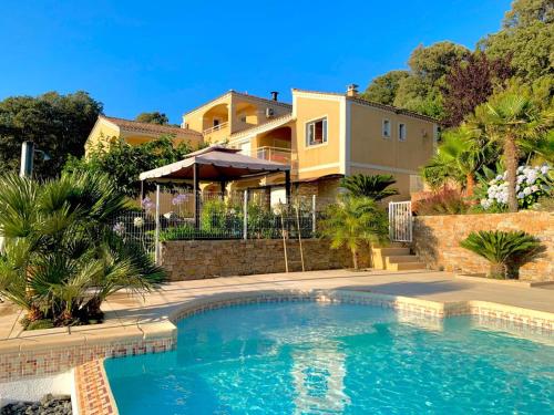 a house with a swimming pool in front of a house at Villa U Tramontu in Granace