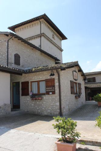 a building with a sign on the side of it at Valle Rosa in Spoleto