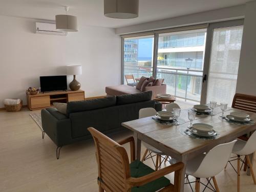 a living room with a table and a couch at Chez Ocean Plaza in Figueira da Foz