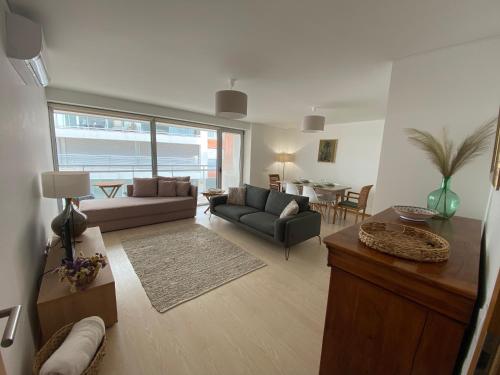 a living room with a couch and a table at Chez Ocean Plaza in Figueira da Foz