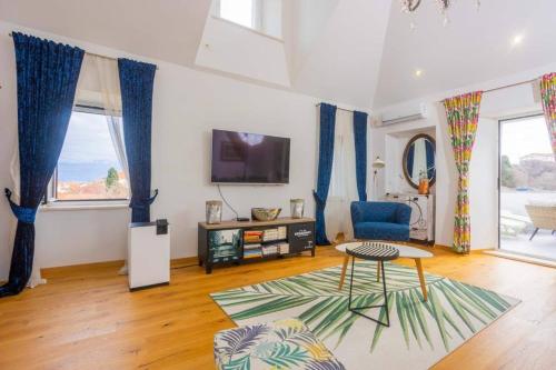 a living room with a table and a tv at Apartment Oskar in Supetar