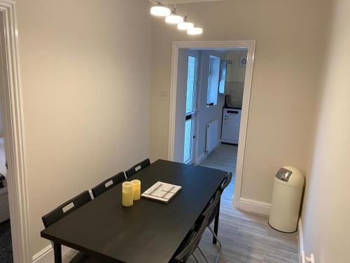 a dining room with a black table and chairs at Washington's Hidden Gem Amethyst 3 Bedroom House s in Washington