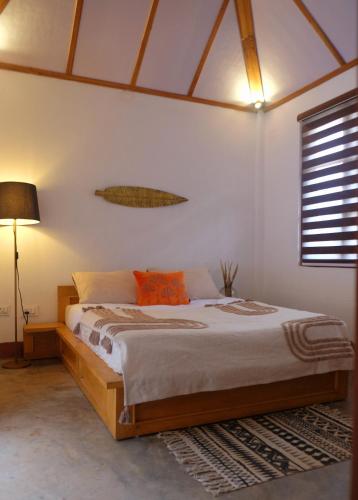 a bedroom with a bed with a wooden frame at TheMalkohaVilla in Umsning
