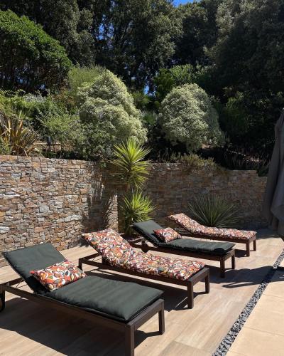 a row of benches with pillows on a patio at Villa U Tramontu in Granace