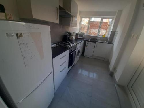a kitchen with white appliances and a white refrigerator at South Shield's Hidden Gem Amethyst 3 Bedroom House in South Shields