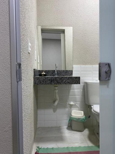 a bathroom with a sink and a toilet at Morada do Lago in Palmas