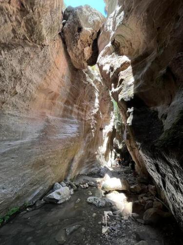 a canyon with rocks and water in a cave at Apartament na Cyprze in Peyia