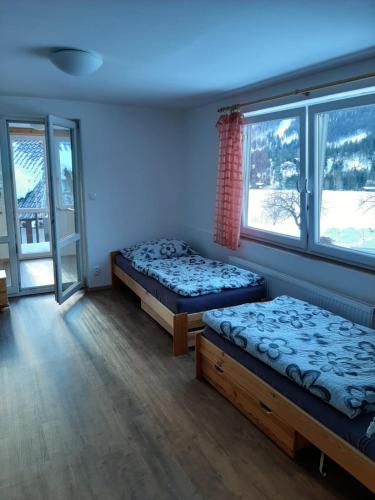 a room with two beds and a window at Rulfik in Hinterberg
