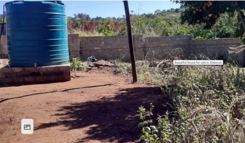 a blue barrel sitting on the side of a dirt road at home 2 home in Kimberley