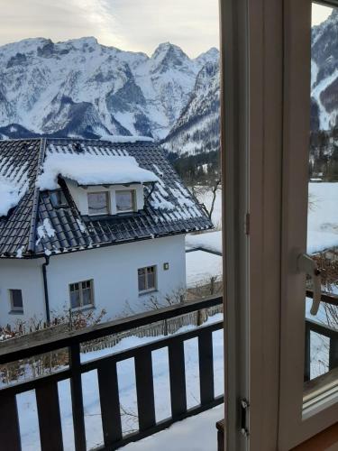 a view of a snowy mountain from a window at Rulfik in Hinterberg