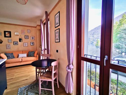 a living room with a couch and a table and a window at AL LAGO by Design Studio in Bellano