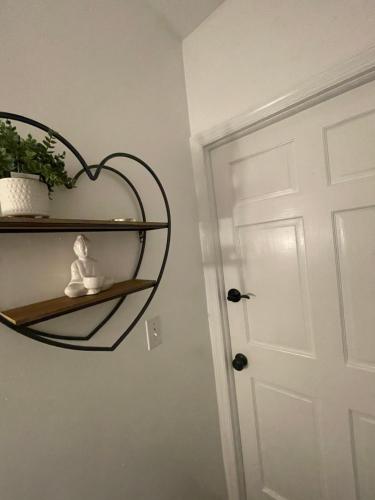a room with a heart shaped shelf next to a door at Verdana Rental NJ in North Bergen