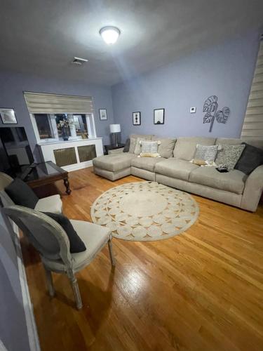 a living room with a couch and a table at Verdana Rental NJ in North Bergen