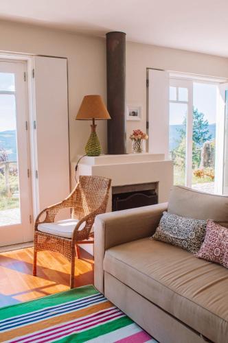 a living room with a couch and a fireplace at Just like Home - Number 8 em Quinta das Mineirinhas in Vila Nova de Cerveira