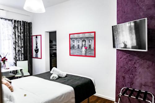 Cette chambre comprend 2 lits et une télévision. dans l'établissement Relais Circo Massimo, à Rome